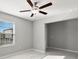 This bedroom has tiled floor and natural lighting from the window at 8918 Parsons Hill Blvd, Wesley Chapel, FL 33545