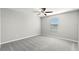This bedroom features a ceiling fan and a window for natural lighting at 8918 Parsons Hill Blvd, Wesley Chapel, FL 33545