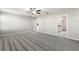 Spacious bedroom with carpet flooring, ceiling fan, and en suite bathroom access for added convenience at 8918 Parsons Hill Blvd, Wesley Chapel, FL 33545