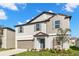 Charming two-story home features a well-manicured lawn and a two-car garage at 8918 Parsons Hill Blvd, Wesley Chapel, FL 33545