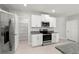 The kitchen has stainless appliances, granite countertops, and white cabinets at 8918 Parsons Hill Blvd, Wesley Chapel, FL 33545