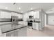 The kitchen has stainless appliances, granite countertops, and white cabinets at 8918 Parsons Hill Blvd, Wesley Chapel, FL 33545