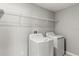 This laundry room features a white washer and dryer at 8918 Parsons Hill Blvd, Wesley Chapel, FL 33545
