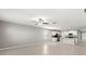 Open-concept living room leading to a modern kitchen with tile floors at 8918 Parsons Hill Blvd, Wesley Chapel, FL 33545