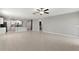 Open-concept living room leading to a modern kitchen with tile floors at 8918 Parsons Hill Blvd, Wesley Chapel, FL 33545