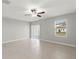 Bright living room showcasing tile flooring, a ceiling fan, and sliding doors leading to the backyard at 8918 Parsons Hill Blvd, Wesley Chapel, FL 33545