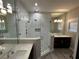 Modern bathroom with a glass-enclosed shower, dual vanities, and designer finishes at 9005 W Flora St, Tampa, FL 33615