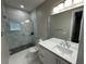 Stylish bathroom featuring a glass-enclosed shower, modern vanity, and sleek fixtures at 9005 W Flora St, Tampa, FL 33615