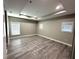 Spacious bedroom with tray ceilings and laminate wood flooring at 9005 W Flora St, Tampa, FL 33615