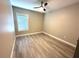 Bright bedroom with a ceiling fan and laminate wood flooring at 9005 W Flora St, Tampa, FL 33615