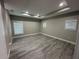 Spacious bedroom with recessed lighting, a tray ceiling, and wood-look flooring at 9005 W Flora St, Tampa, FL 33615