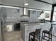 Outdoor kitchen with stainless steel appliances, gray cabinets, and granite countertops at 9005 W Flora St, Tampa, FL 33615