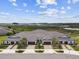 Vast aerial image presenting modern homes with garages, complemented by a serene lake backdrop at 10282 Echo Dock Loop, San Antonio, FL 33576