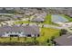 Expansive aerial shot of a residential area with modern homes, lakes, and lush greenery at 10282 Echo Dock Loop, San Antonio, FL 33576