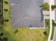 Aerial shot of a well-maintained roof, green lawn, and the brick driveway at 10282 Echo Dock Loop, San Antonio, FL 33576