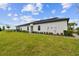 Expansive backyard with lush lawn and manicured landscaping under a clear blue sky at 10282 Echo Dock Loop, San Antonio, FL 33576