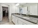 Bathroom features a dual-sink vanity, granite countertops and is conveniently located next to the walk-in closet at 10282 Echo Dock Loop, San Antonio, FL 33576