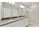 Bathroom features a double vanity sink, granite counters, a tiled glass enclosed shower and neutral finishes at 10282 Echo Dock Loop, San Antonio, FL 33576