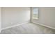 This bedroom has neutral walls, plush carpet and a large window at 10282 Echo Dock Loop, San Antonio, FL 33576