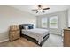 This bedroom features a comfortable bed with blue patterned cover and natural light from two windows at 10282 Echo Dock Loop, San Antonio, FL 33576