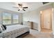 Light-filled bedroom includes a ceiling fan, soft carpeting, two windows, and a dresser, creating a relaxing retreat at 10282 Echo Dock Loop, San Antonio, FL 33576