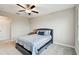 Cozy bedroom with a queen bed featuring a decorative headboard, soft carpet, and ample natural light at 10282 Echo Dock Loop, San Antonio, FL 33576