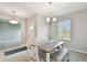 Casual dining room with pendant lighting, neutral decor, and view into the entry way at 10282 Echo Dock Loop, San Antonio, FL 33576