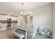 Casual dining room with chandelier, neutral decor, open to the kitchen and connected to living area at 10282 Echo Dock Loop, San Antonio, FL 33576
