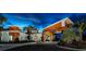 Modern community clubhouse featuring wood accents, manicured landscaping, and inviting entrance at 10282 Echo Dock Loop, San Antonio, FL 33576
