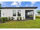 Exterior view showcases the home's patio, well-manicured lawn, and tasteful landscaping at 10282 Echo Dock Loop, San Antonio, FL 33576