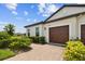 Beautiful home showcasing manicured shrubs, a brick walkway, and a charming facade at 10282 Echo Dock Loop, San Antonio, FL 33576