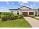 Charming home featuring a well-manicured lawn, a brick driveway, and a two-car garage at 10282 Echo Dock Loop, San Antonio, FL 33576