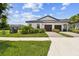 Charming home featuring a well-manicured lawn, a sidewalk, and a two-car garage at 10282 Echo Dock Loop, San Antonio, FL 33576