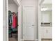 Hallway features a walk-in closet and bathroom with double granite vanity sinks, ensuring ample space at 10282 Echo Dock Loop, San Antonio, FL 33576