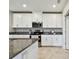 Bright kitchen boasts stainless steel appliances, granite countertops, and white cabinets and drawers at 10282 Echo Dock Loop, San Antonio, FL 33576