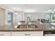 Kitchen island featuring a stainless sink, granite countertop, and stainless steel dishwasher in a home at 10282 Echo Dock Loop, San Antonio, FL 33576