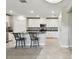 Kitchen with white cabinets, granite countertops, stainless steel appliances, and island with barstool seating at 10282 Echo Dock Loop, San Antonio, FL 33576
