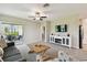 Bright living room with patio access, neutral walls, carpet, casual furnishings, and a TV at 10282 Echo Dock Loop, San Antonio, FL 33576