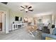 Open living room features neutral paint, carpet flooring, casual furnishings, and adjacent dining and kitchen at 10282 Echo Dock Loop, San Antonio, FL 33576