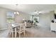 Combined dining and living room with neutral walls and carpet, featuring a wooden table and casual seating at 10282 Echo Dock Loop, San Antonio, FL 33576