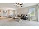Bright living room featuring neutral paint, carpet flooring, casual furnishings, ceiling fan, and natural light at 10282 Echo Dock Loop, San Antonio, FL 33576