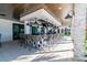 Covered outdoor bar area featuring stone pillars, granite countertops, and comfortable seating at 10282 Echo Dock Loop, San Antonio, FL 33576