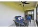 Covered patio offering cozy wicker furniture, a ceiling fan, and a relaxing outdoor space at 10282 Echo Dock Loop, San Antonio, FL 33576