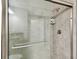 Shower with gray tiles and a glass door at 10282 Echo Dock Loop, San Antonio, FL 33576