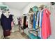 Walk-in closet boasts ample storage with organized hanging racks, shelves, and space for personal items at 10282 Echo Dock Loop, San Antonio, FL 33576