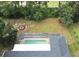 Aerial view of pool, backyard, and screened-in enclosure and fire pit at 10287 Fordham St, Spring Hill, FL 34608