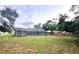 Spacious backyard with a screened-in pool and plenty of green space at 10287 Fordham St, Spring Hill, FL 34608