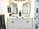 Beautiful bathroom features dual sinks, framed mirrors, modern vanity and hardware at 10287 Fordham St, Spring Hill, FL 34608