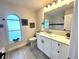 Bathroom featuring a modern vanity with granite countertops, a new sink, and neutral paint at 10287 Fordham St, Spring Hill, FL 34608
