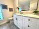 Updated bathroom with a large mirror, granite countertops, and ample cabinet space at 10287 Fordham St, Spring Hill, FL 34608